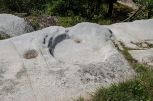 Indentations in a rock used for wine production during Roman time